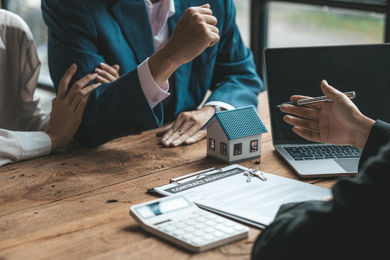 A couple is approaching a housing project to buy and they are discussing details and advice with a salesperson in a housing project real estate trading ideas with couples